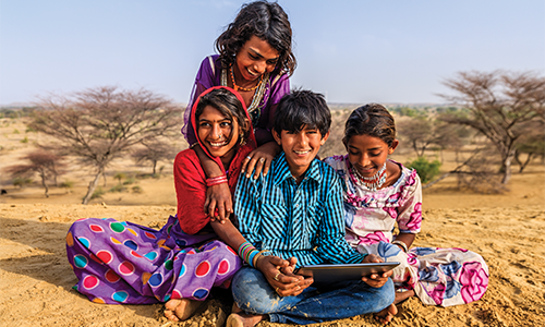 Children playing on a Tablet with Internet in India