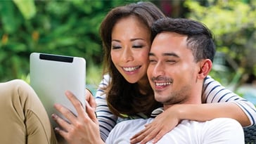 couple on tablet smiling