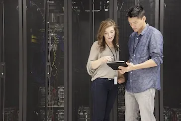 A woman and man looking at a tablet together