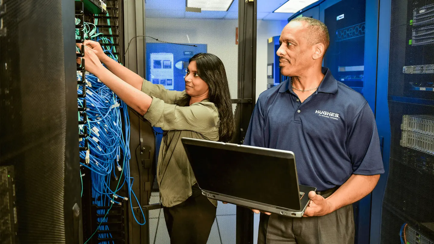 Hughes employees working in server room