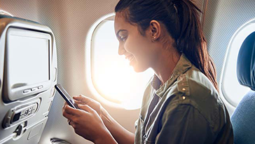 woman using in-flight connectivity