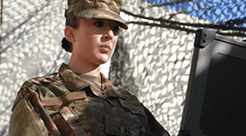 A military person looking at a laptop