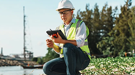 A construction working looked at a tablet outdoors