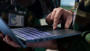 Military personnel using laptop