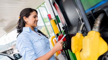 Woman using a gas pump