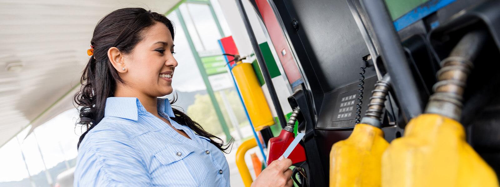 Woman paying for gas at pump