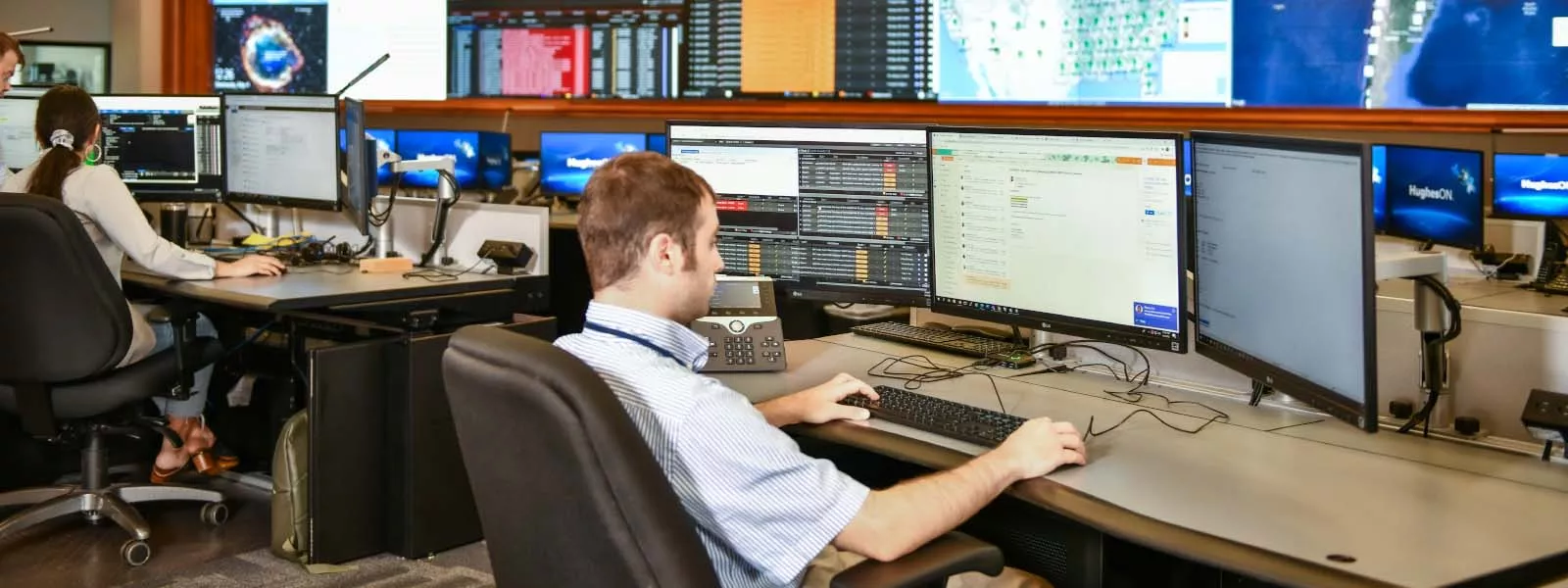 Hughes Employee working at desk