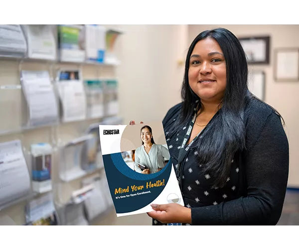 hughes employee holding a health brochure 