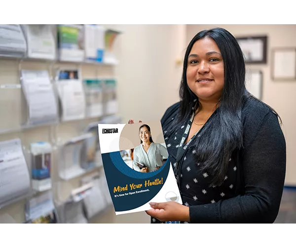 hughes employee holding a health brochure 