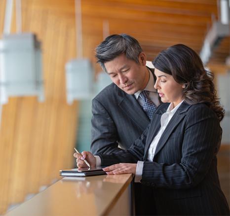 Man and woman looking at a tablet together 