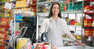 Convenience store employee at register