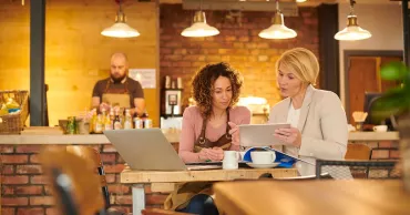 workers in restaurant looking at device screens