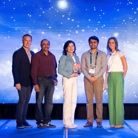 Hughes team on stage, honored by Ericsson as Partner of the Year