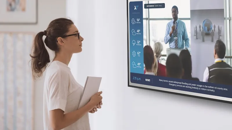 Image of woman looking at breakroom TV screen