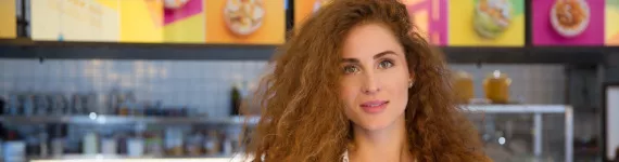 woman standing in front of digital menu boards