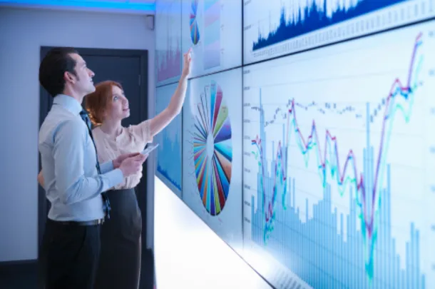 two colleagues looking at charts