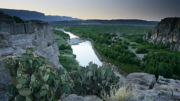 A rocky landscape with a river running through