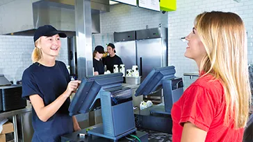 A woman ordering at a restaurant.