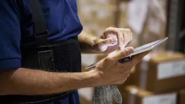Person looking at a tablet.