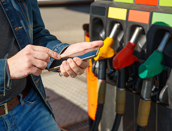 Refueling a car and paying using the application on a smartphone.; Shutterstock ID 1730192101; purchase_order: