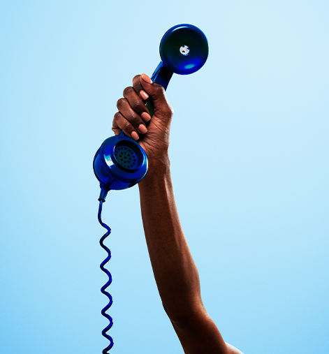 blue landline phone being held in the air