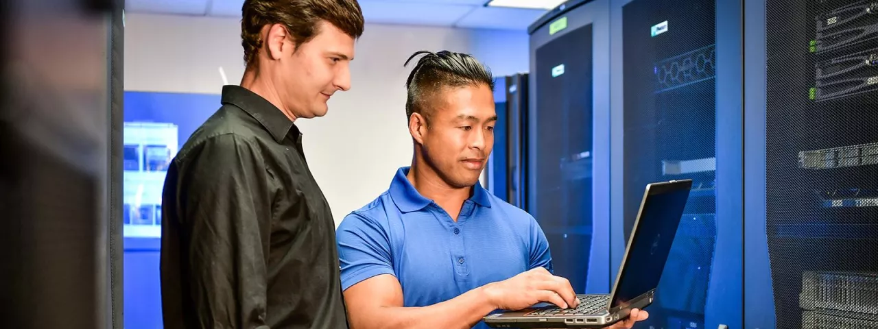 Hughes employees in server room