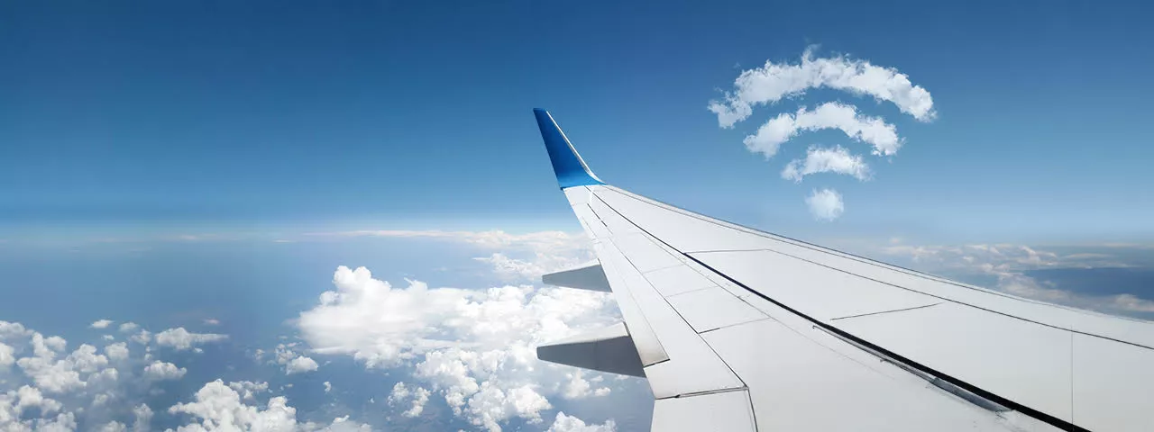 wifi symbol in clouds next to plane wing