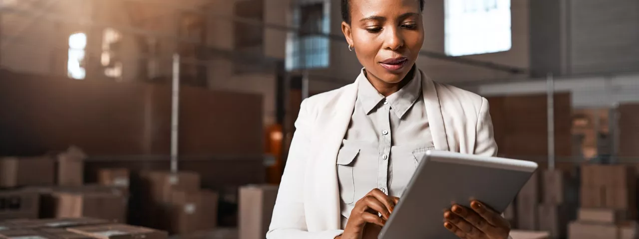 woman using tablet in warehouse facility