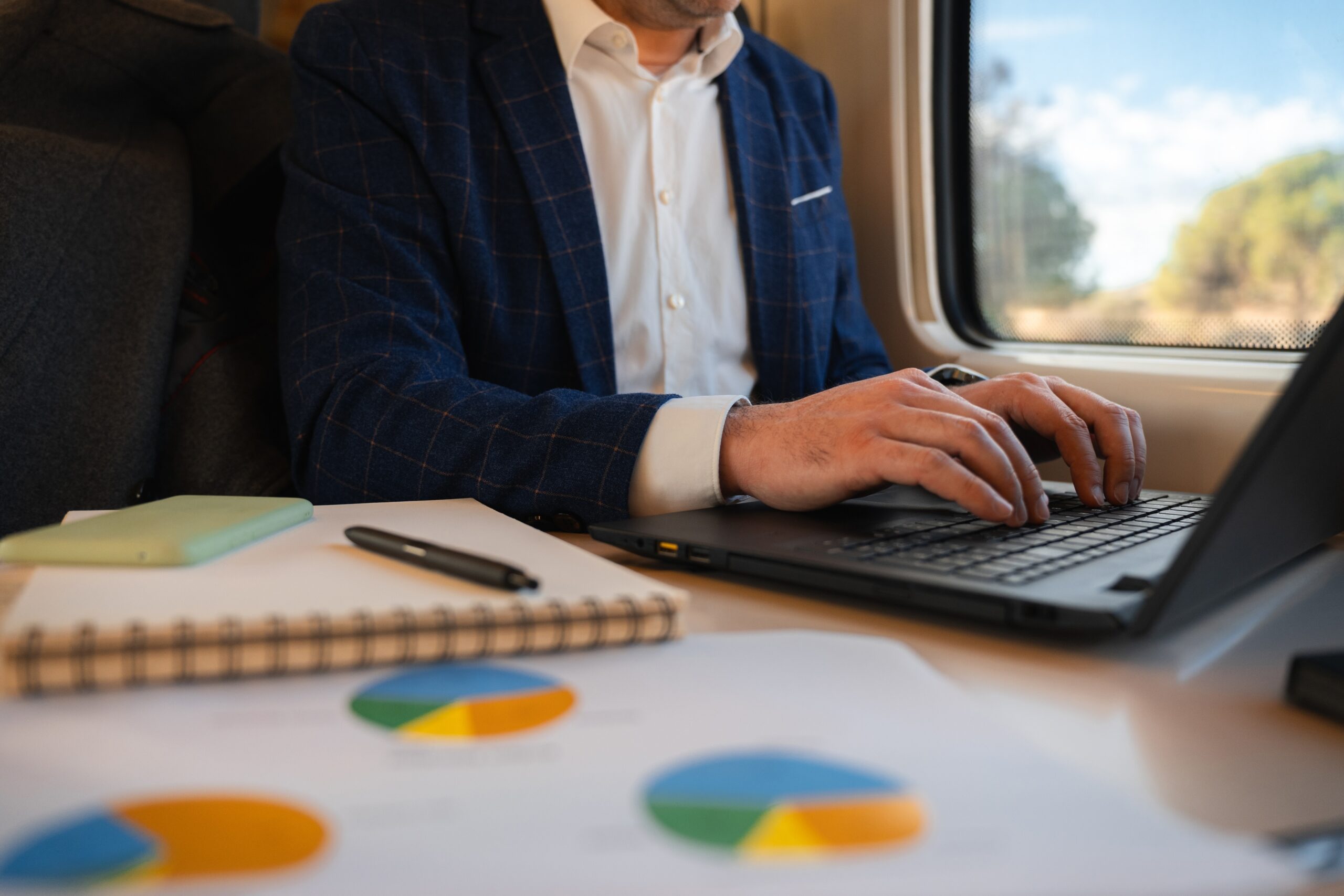 A passenger on a train with a laptop