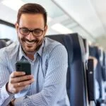 A man on his phone on a train