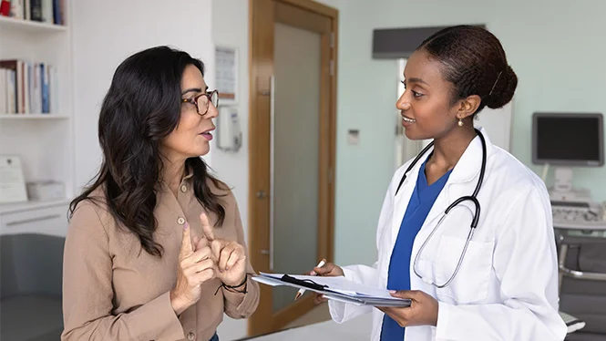 A doctor speaking to a patient.