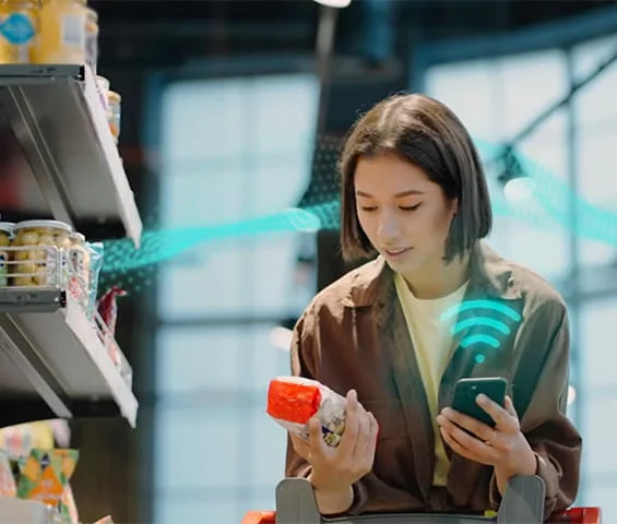 A woman in a grocery store using her phone